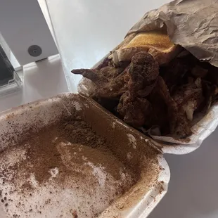 a half eaten sandwich and half eaten fries