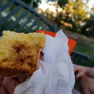 a person holding a piece of food