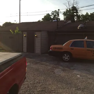 a taxi cab parked in front of a garage