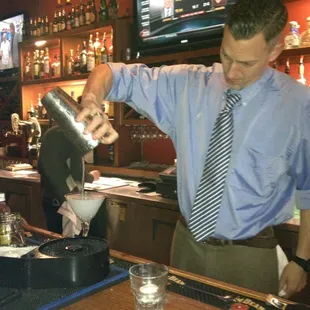 a bartender pouring a drink