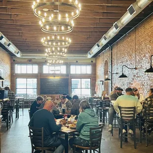people sitting at tables in a restaurant