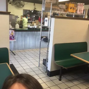 Kitchen. seating area. weird random shelves with boxes of "new" stuff.