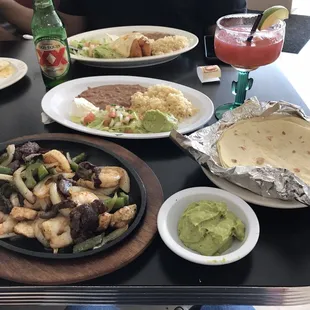 3 way fajitas (steak, chicken &amp; shrimp), with beans, rice, guacamole &amp; sour cream. Accompanied with a strawberry mango margarita