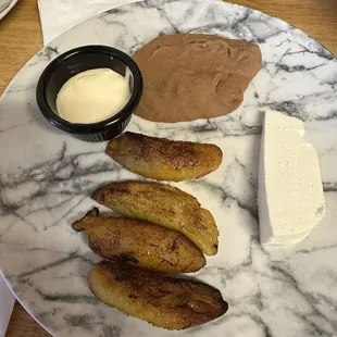 Platano frito with cheese, beans, and crema