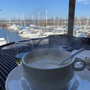 a bowl of milk and a spoon on a table