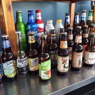 a variety of beer bottles on a shelf