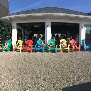 a group of people sitting in brightly colored chairs