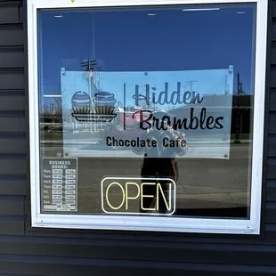 Front window sign and hours.