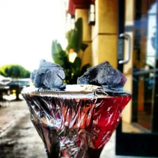 two birds perched on a glass bowl