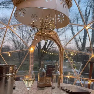 a table with wine glasses and a menu