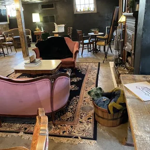 Inside is warm and inviting with a fireplace, throw blankets, and comfy couches.