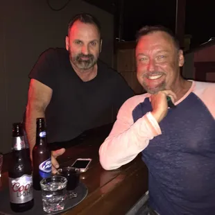 two men sitting at a bar