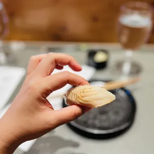 a hand holding a piece of food