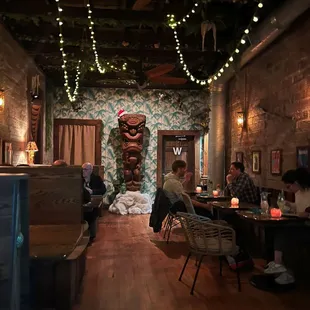 people sitting at tables in a restaurant