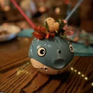 a blue vase with flowers in it