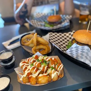 Small spicy tots &amp; Small Beer Battered Onion Rings Burgers in the background