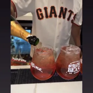 a baseball player pouring a drink