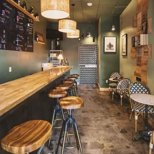 a bar with stools and tables