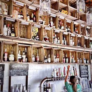 a woman reaching up to grab a drink