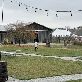 a woman in a white dress standing in the yard