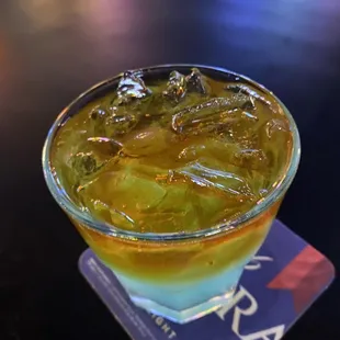 a drink in a glass on a coaster