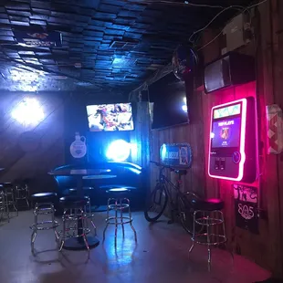 a neon sign and bar stools