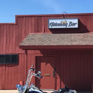 a motorcycle parked in front of a red building