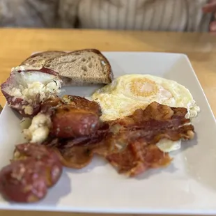 Over easy eggs, bacon, smashed potatoes and sourdough toast.
