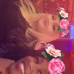 two women with flowers in their hair