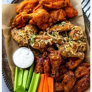 a platter of chicken wings, carrots, celery, and ranch dressing