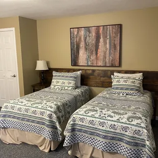 2 single beds in the same room that appear that you can push together if needed.