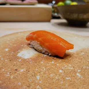 a piece of sushi sitting on top of a pancake