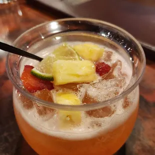 Gorgeous Prohibition Punch with fruit vodka, lime, strawberry syrup, and fresh fruit on top! Delicious!
