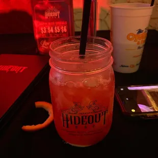 a drink in a mason jar with a straw