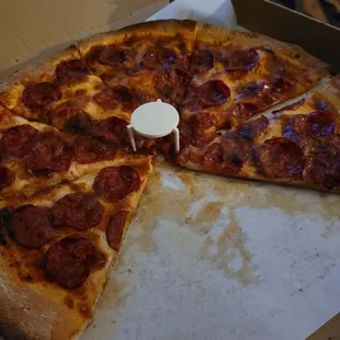 a half eaten pepperoni pizza