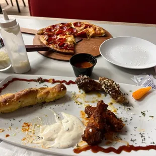 Garlic parm and buffalo wings and pepperoni pizza