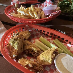 Wings, cheese fries, and part of a burger