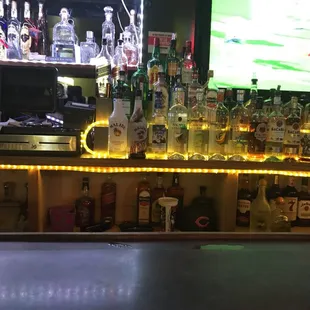 a bar with a lot of bottles of alcohol