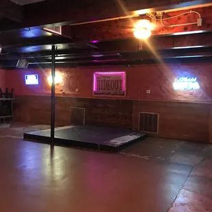 a dance floor and neon signs