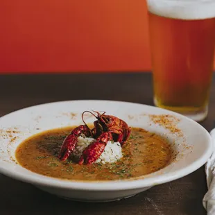 a bowl of soup and a glass of beer