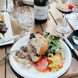 a woman sitting at a table with a plate of food