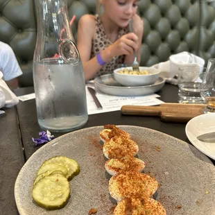 Deviled eggs small plate with homemade pickles.  Daughter enjoying the Mac n cheese kids meal. A glimpse of the whiskey flight to the right.