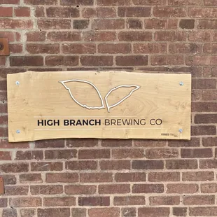 a sign on a brick wall