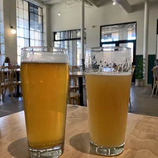 two glasses of beer on a table