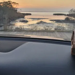 a view of the ocean from inside a car