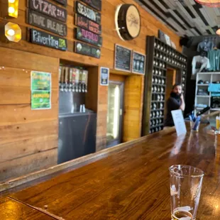 the bar with a glass of beer