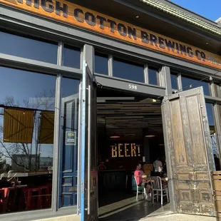 Front doors with beer sign luring us in