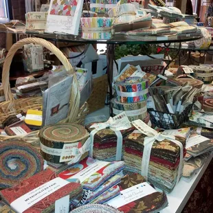 Table of jelly rolls and charm packs, etc.