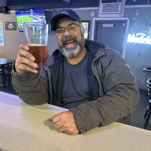 a man holding a glass of beer