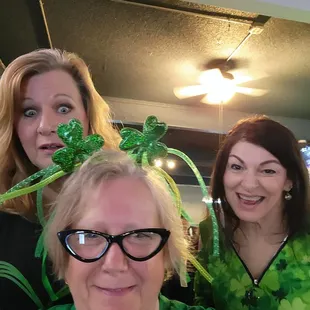 a group of women dressed in st patrick&apos;s day attire